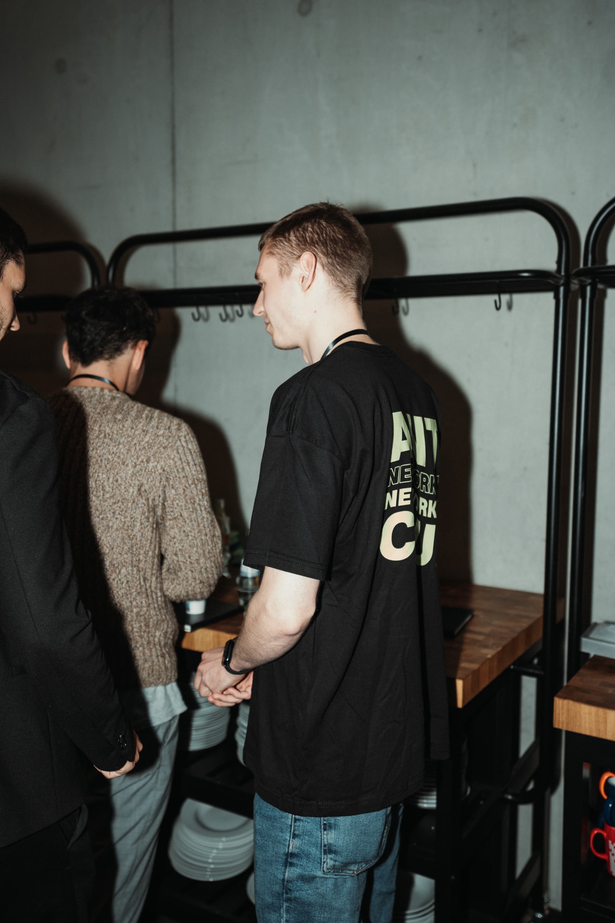 Backstage at the event, graphic type on a black shirt